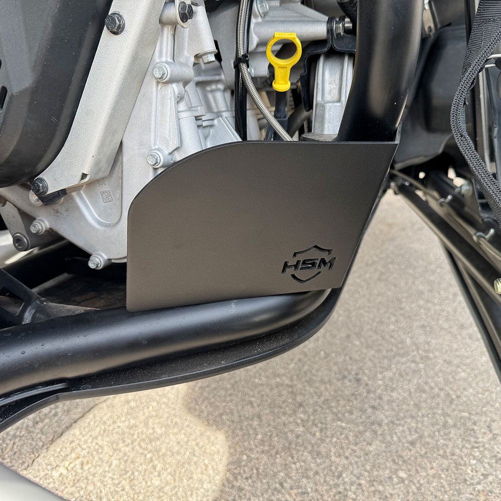
                  
                    Close-up of installed HSM oil filter guard on Polaris RZR PRO R, positioned below the engine and dipstick.
                  
                