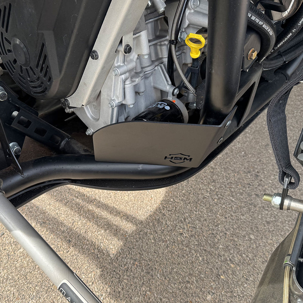 
                  
                    HSM oil filter guard mounted on Polaris RZR PRO R, showing alignment with oil filter and engine block.
                  
                
