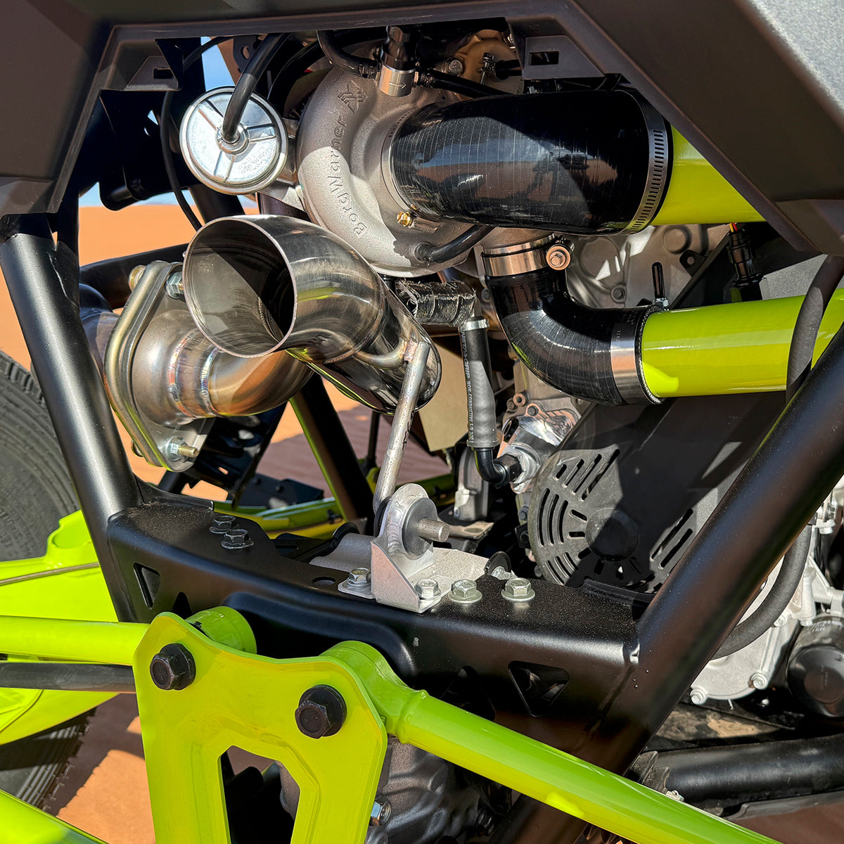 
                  
                    Close-up view of the installed BorgWarner turbocharger and high-flow exhaust system from the H&S Motorsports Easy Boost Turbo Kit on a Polaris RZR Pro R.
                  
                