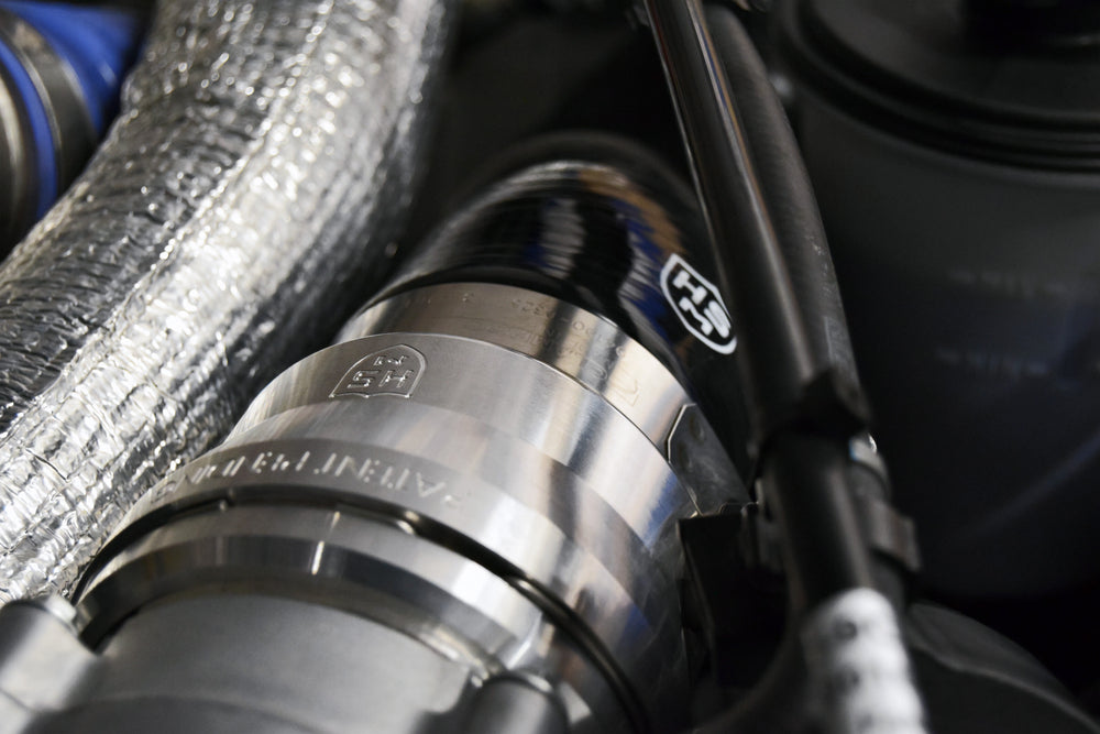
                  
                    Detailed view of H&S Motorsports billet adapter connected to the 5-ply silicone hose installed on 6.7L Power Stroke engine.
                  
                